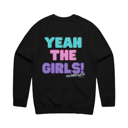 A black crewneck sweatshirt with the text 'YEAH THE GIRLS!' printed on the front in bold letters, featuring a mix of pink and blue colors.
