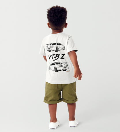 Child wearing a white t-shirt with graphic designs and text, standing against a plain background